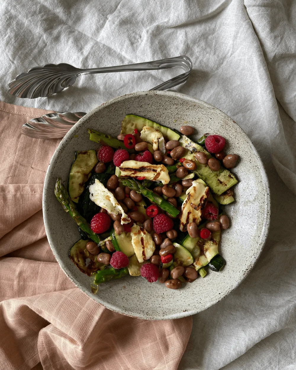Grillede squash og asparges med marinerede hestebønner, hindbær og halloumi